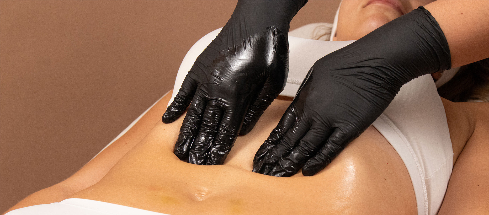 Close up of a woman receiving a cosmetic treatment on her abdomen. 