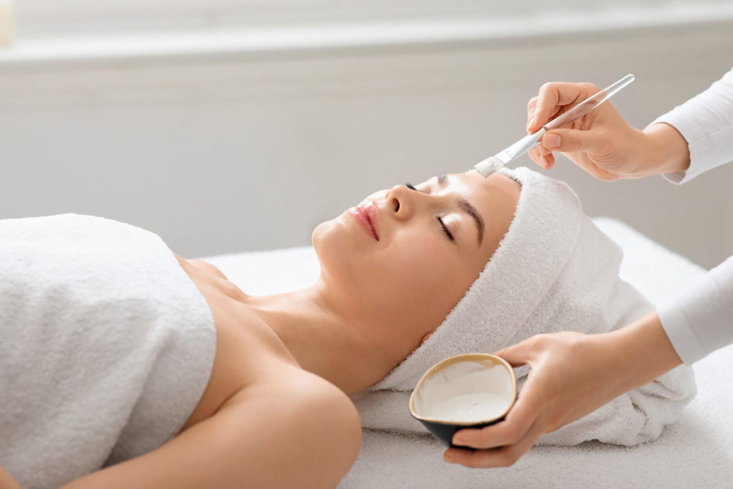 A woman receiving a facial.