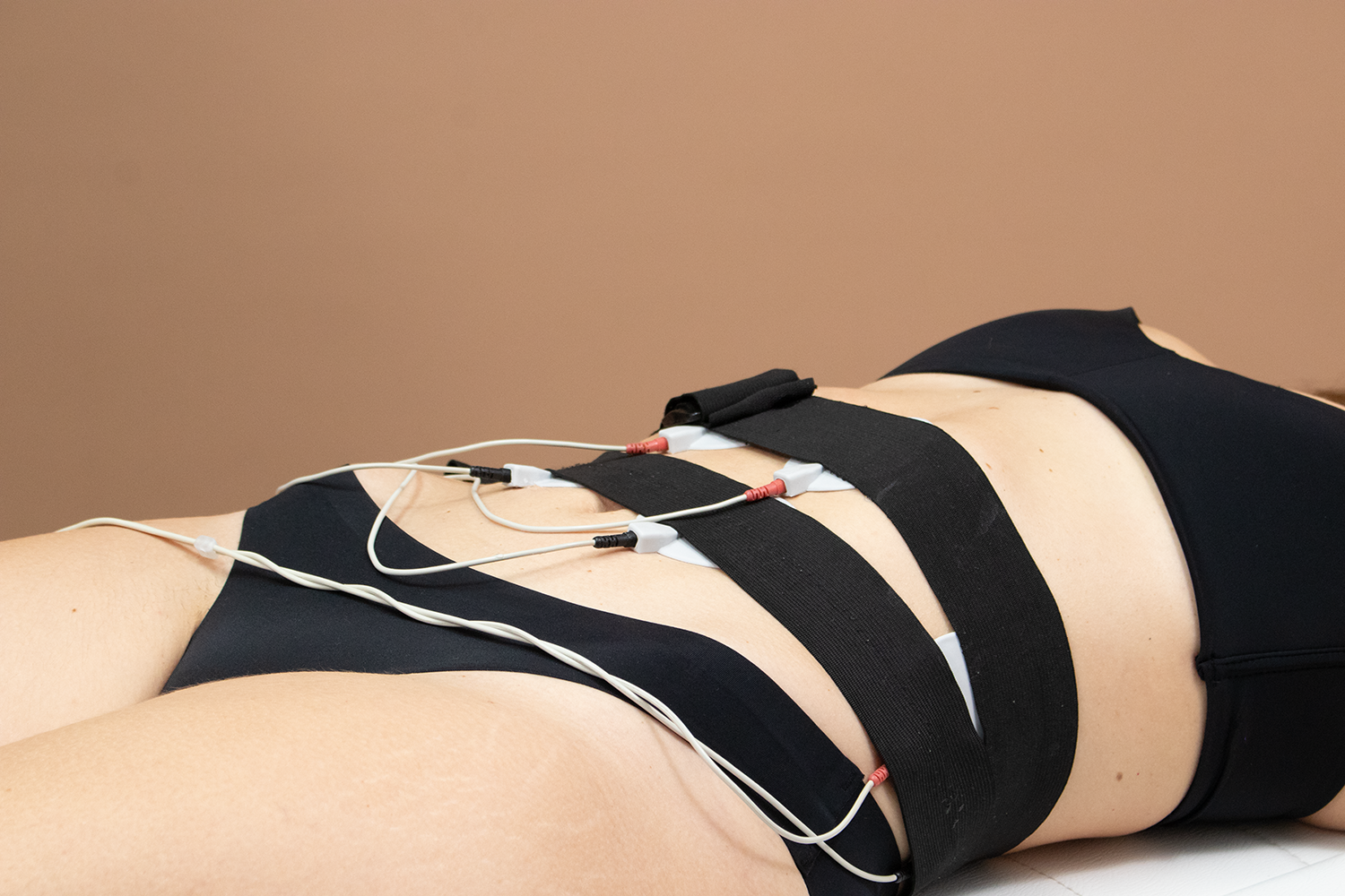 A woman receiving a cosmetic treatment on her abdomen. 