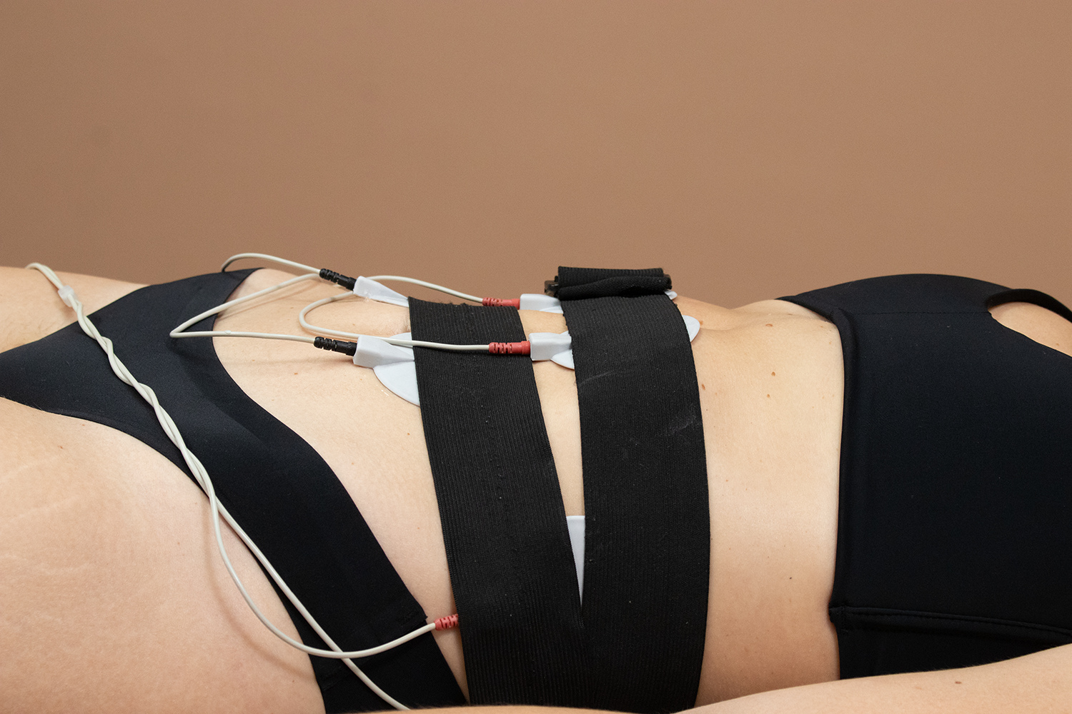 A woman receiving a cosmetic treatment on her abdomen. 