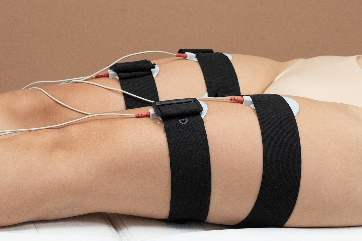 A woman receiving a cosmetic treatment on her abdomen. 