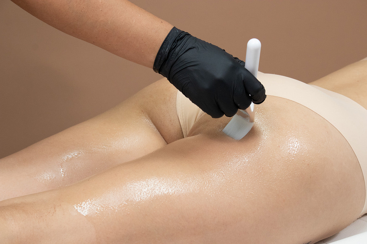 A woman receiving a cosmetic treatment on her thighs.