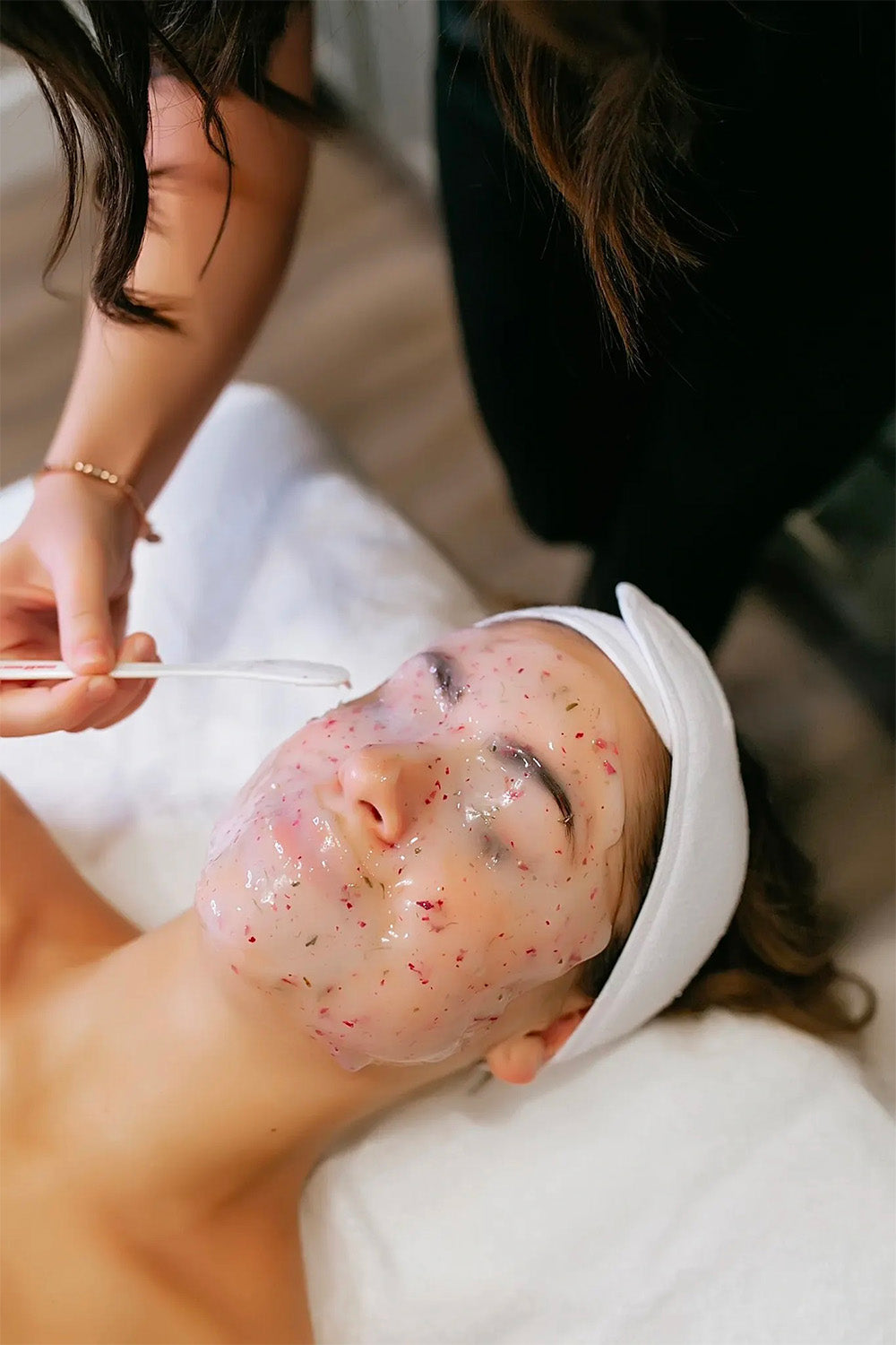 Close up of the face of a woman recieving an Egyptian Rose Facial.